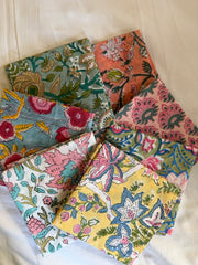 Collection of colorful floral fabric swatches on a white background