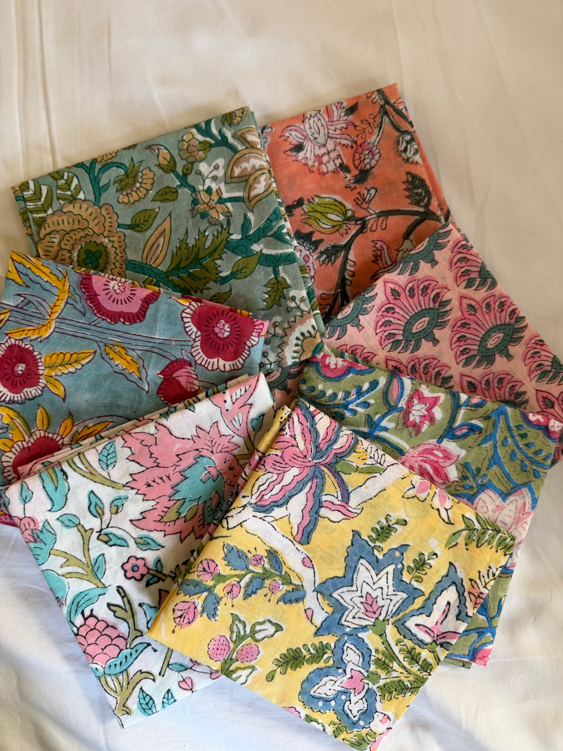 Collection of colorful floral fabric swatches on a white background
