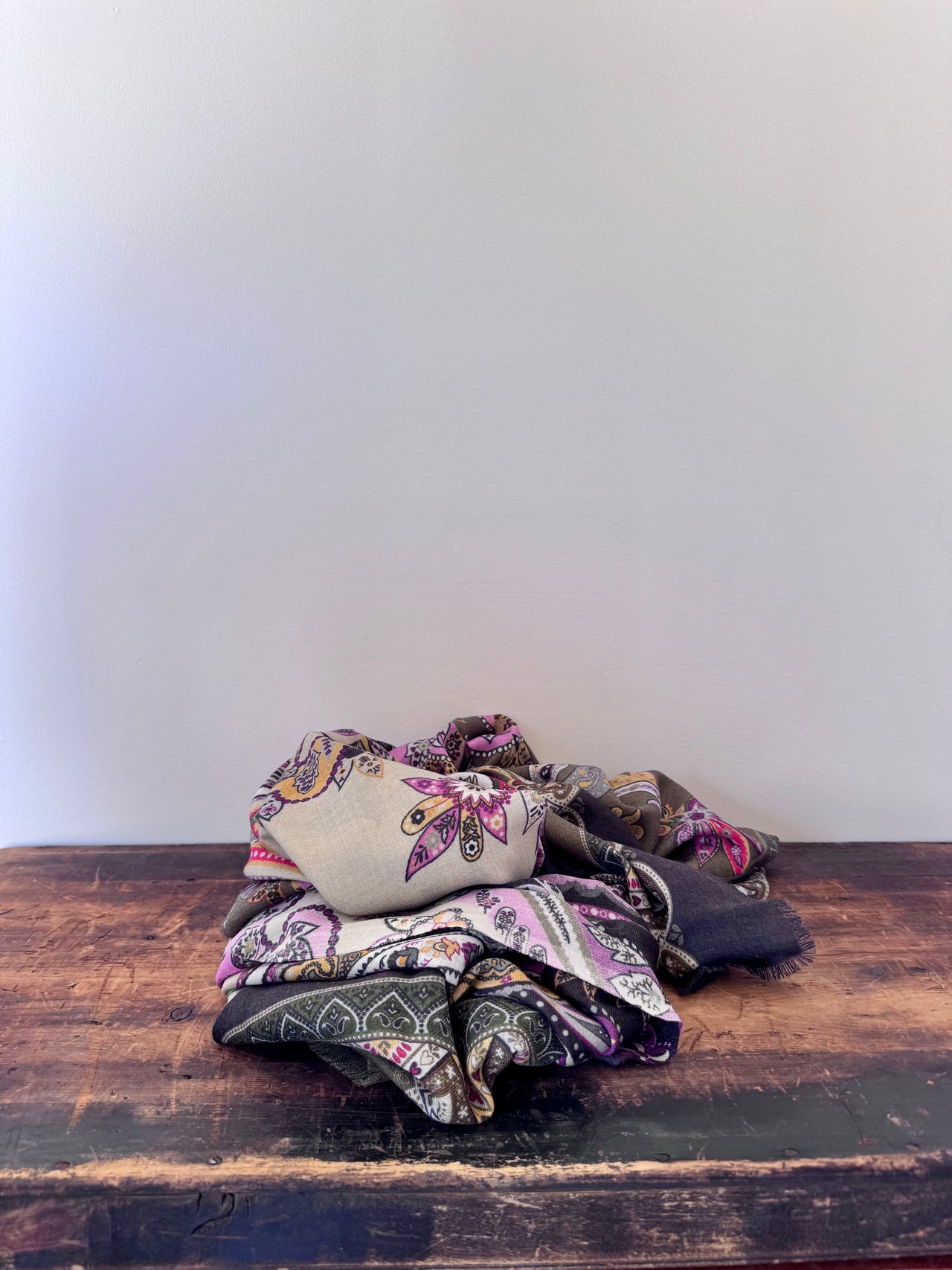 Patterned fabric on a wooden surface with a white background
