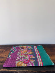 Colorful patterned fabric on a wooden surface
