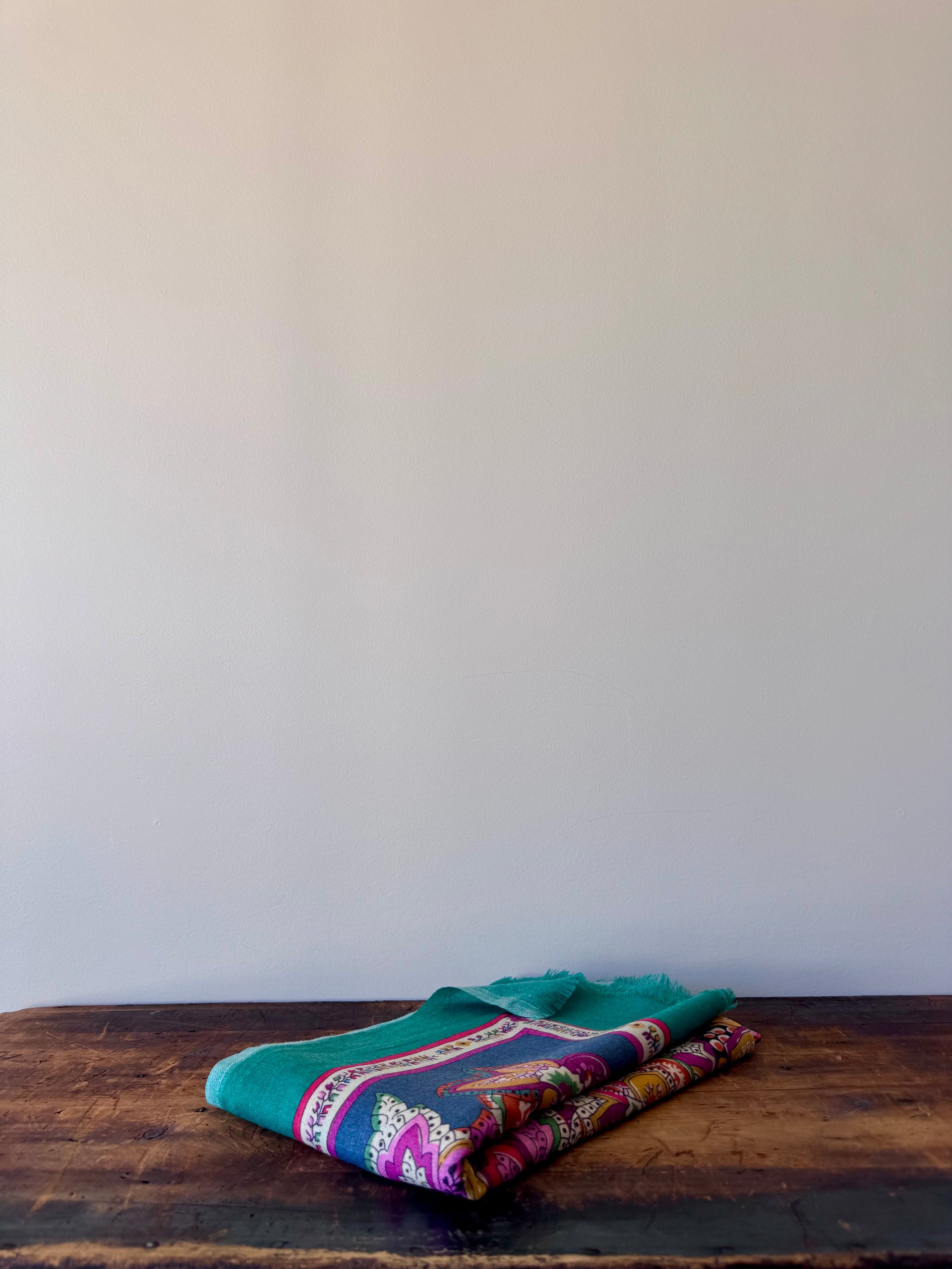 Colorful fabric on a wooden surface with a white background