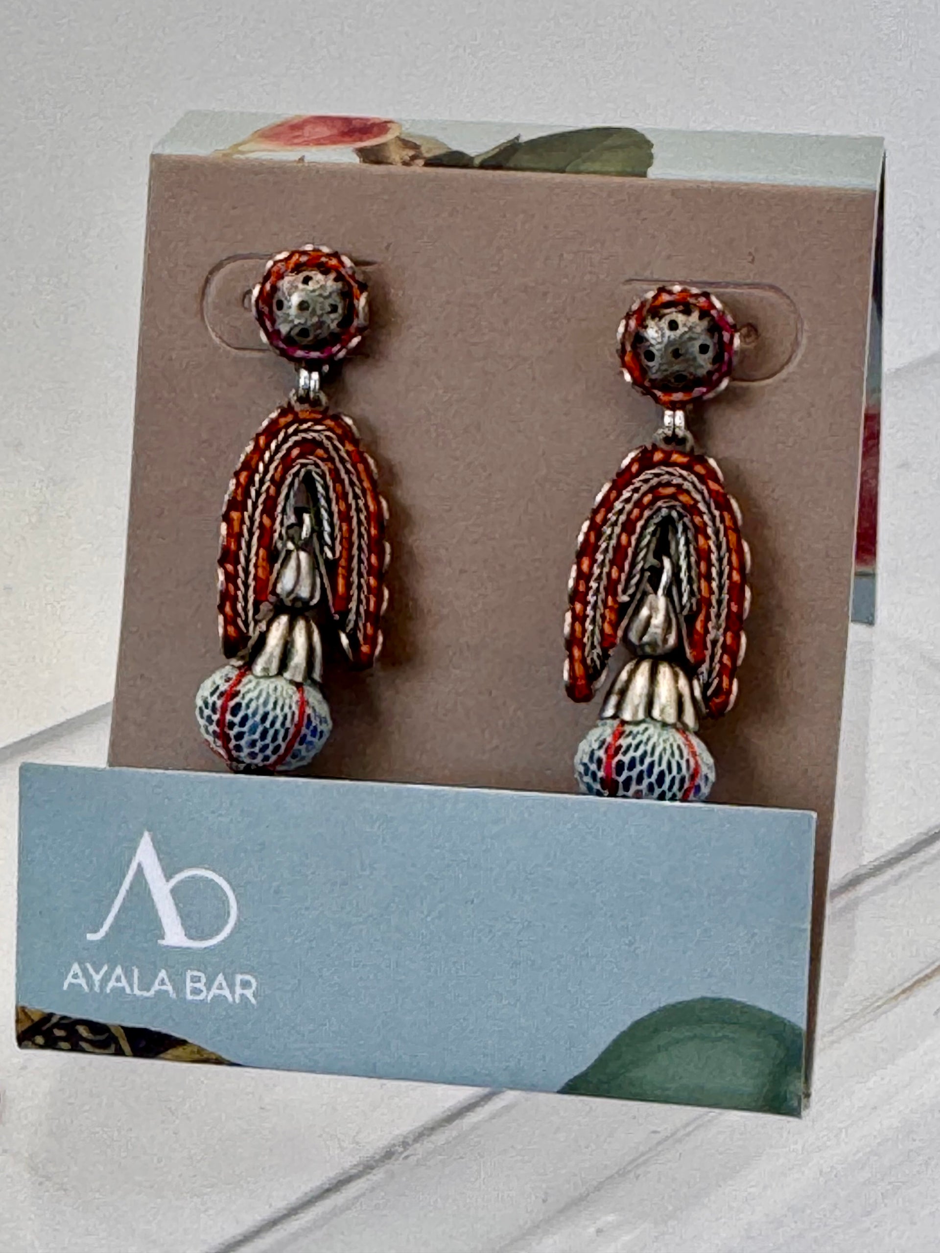 Pair of earrings on a display card with Ayala Bar logo