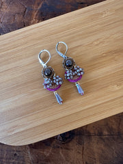 Pair of earrings on a wooden surface