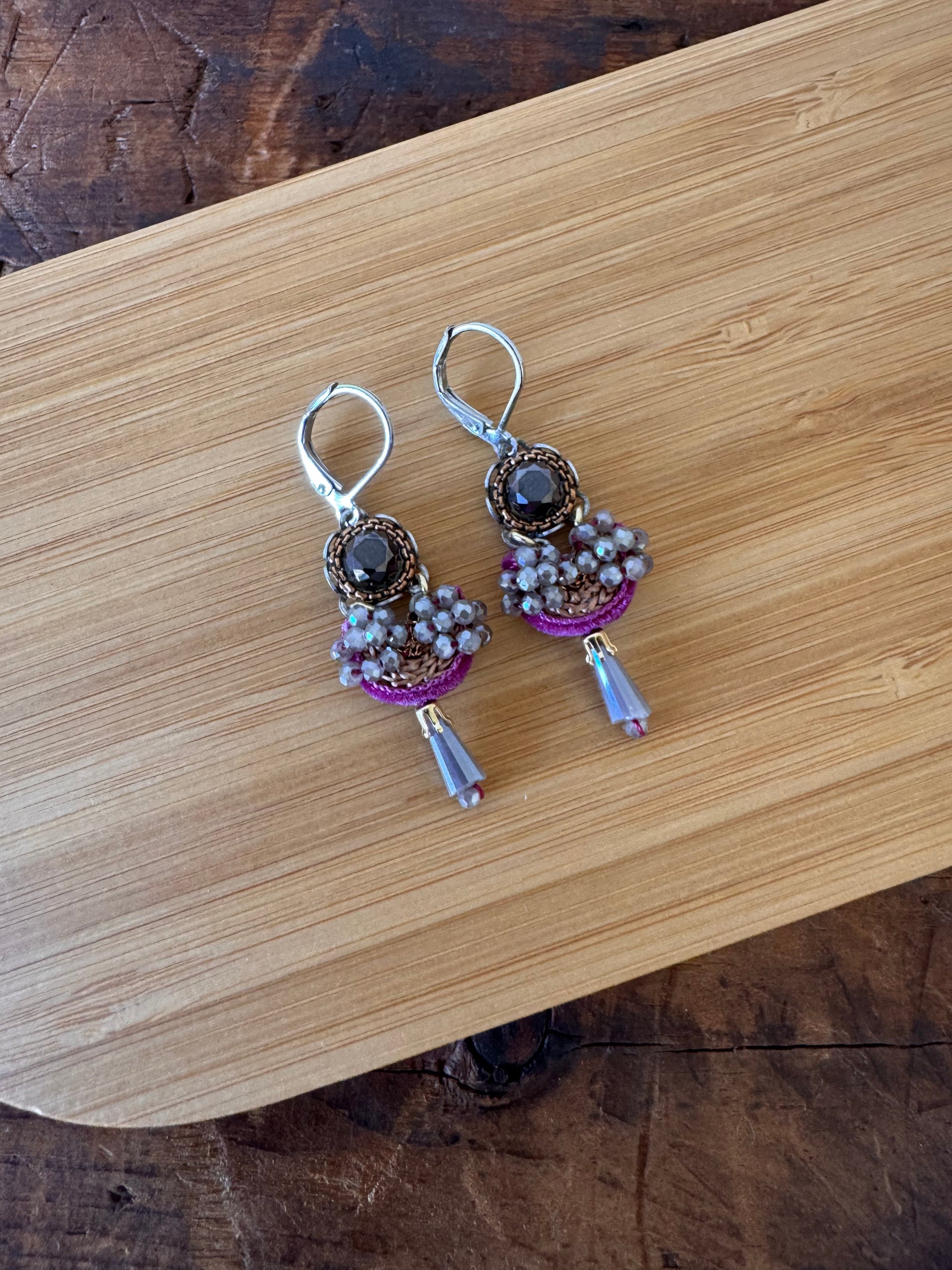 Pair of earrings on a wooden surface