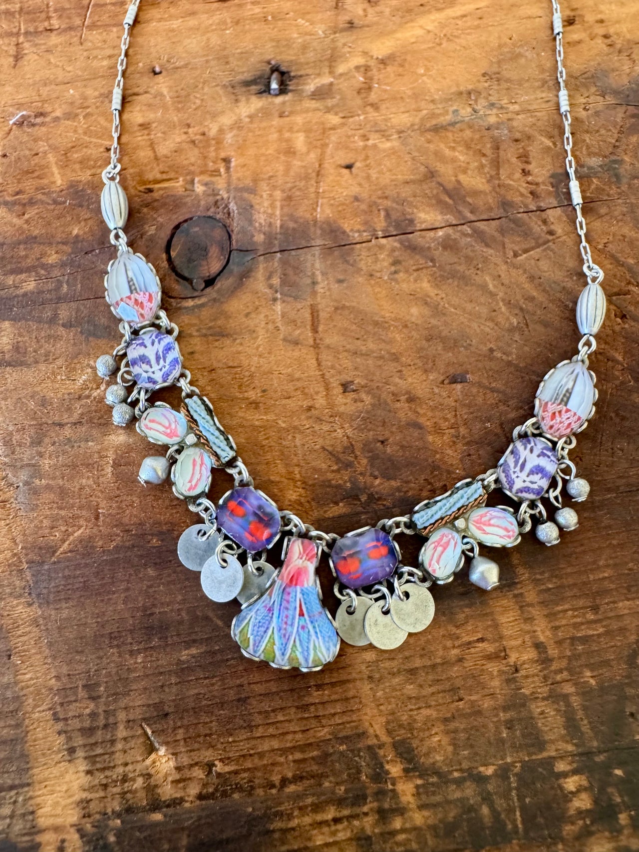 Necklace with colorful charms on a wooden surface