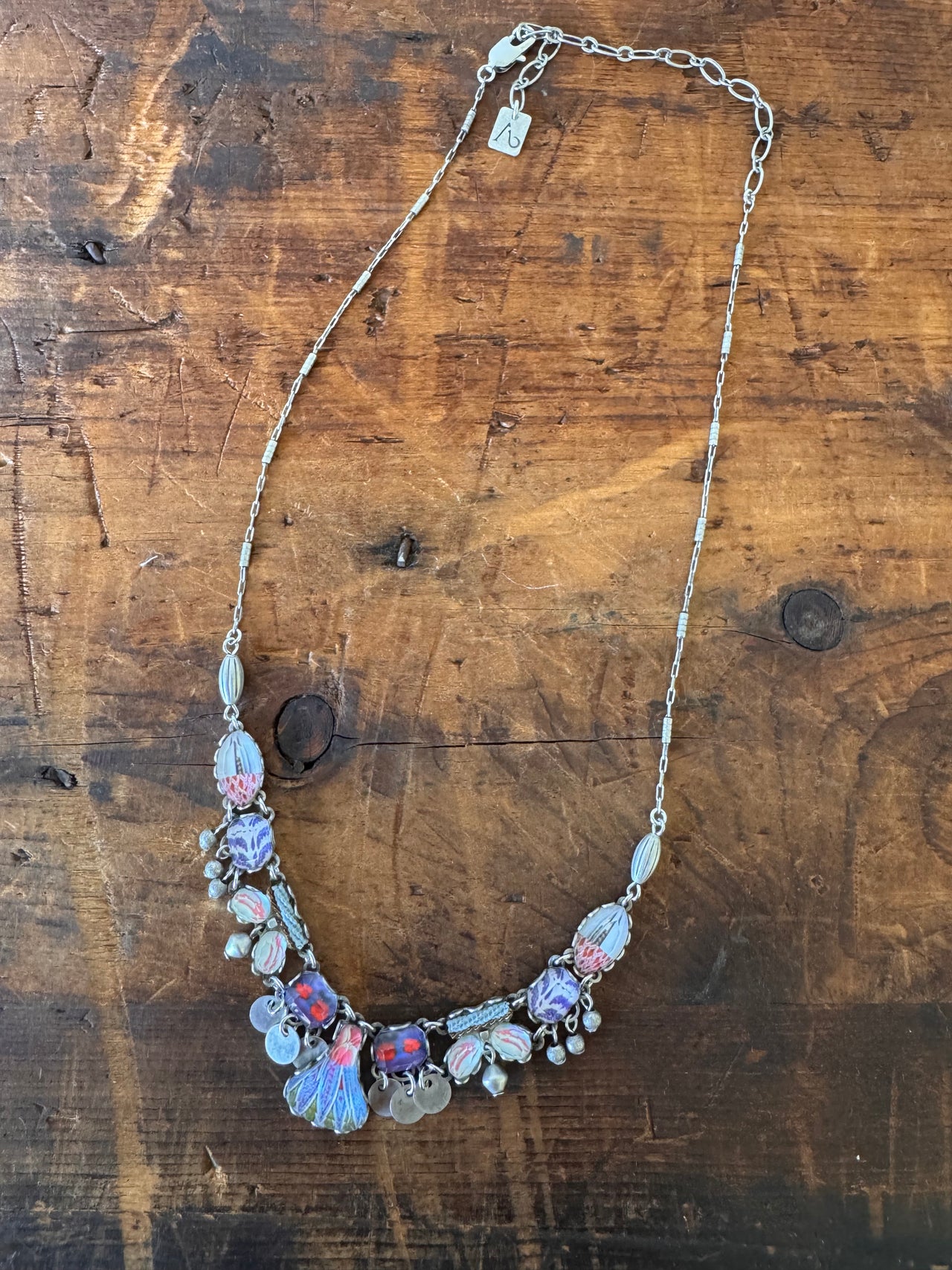 Necklace with floral design on a wooden surface