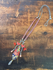 Colorful beaded necklace on a wooden surface