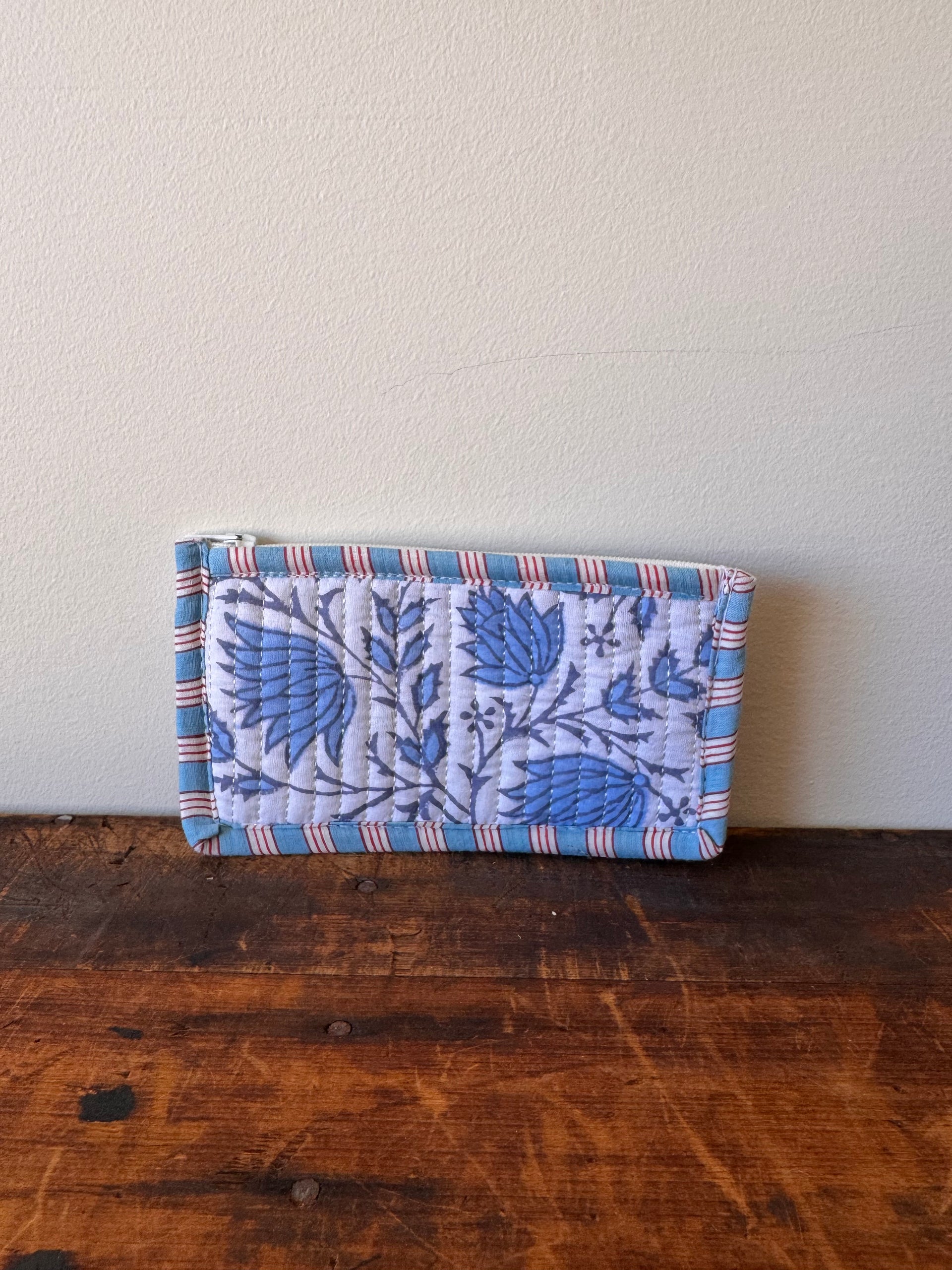 Floral-patterned fabric roll on a wooden surface