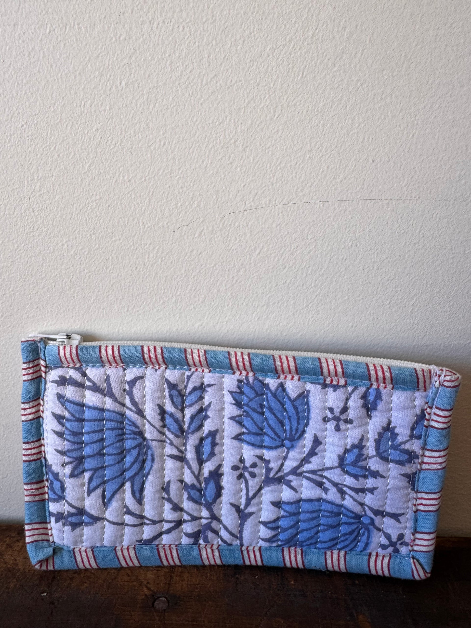 Floral-patterned fabric roll on a textured surface