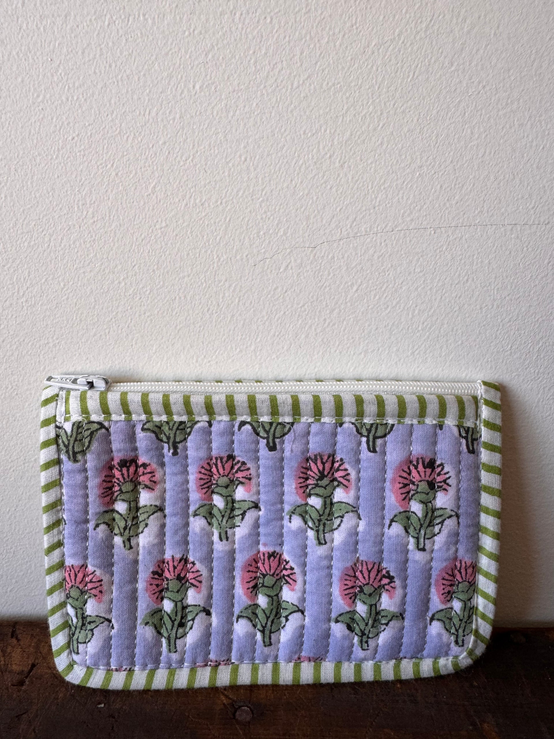 Small pouch with floral pattern on a textured surface
