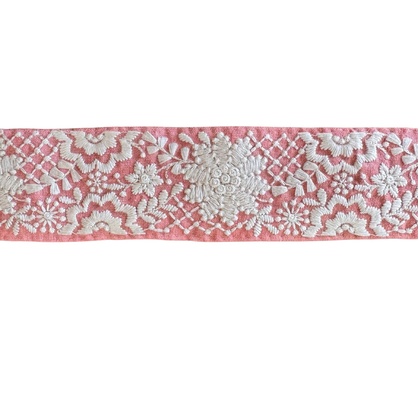 Embroidered lace trim on a pink background