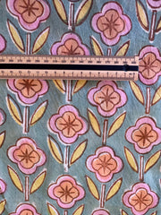 Floral patterned fabric with a ruler for scale on a blue background