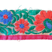 Embroidered fabric strip with colorful flowers and leaves on a white background