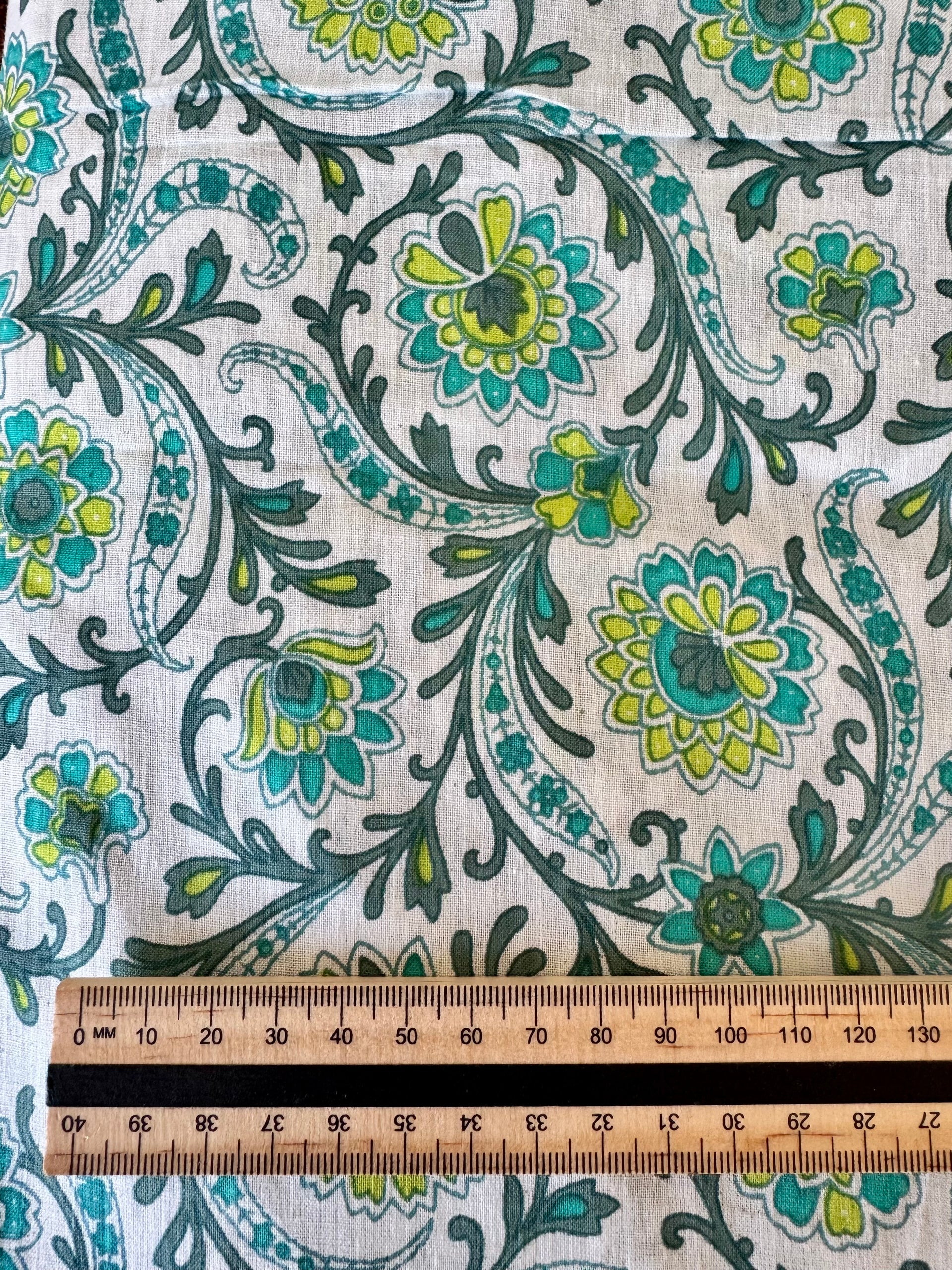 Floral patterned fabric with a ruler for scale on a white background