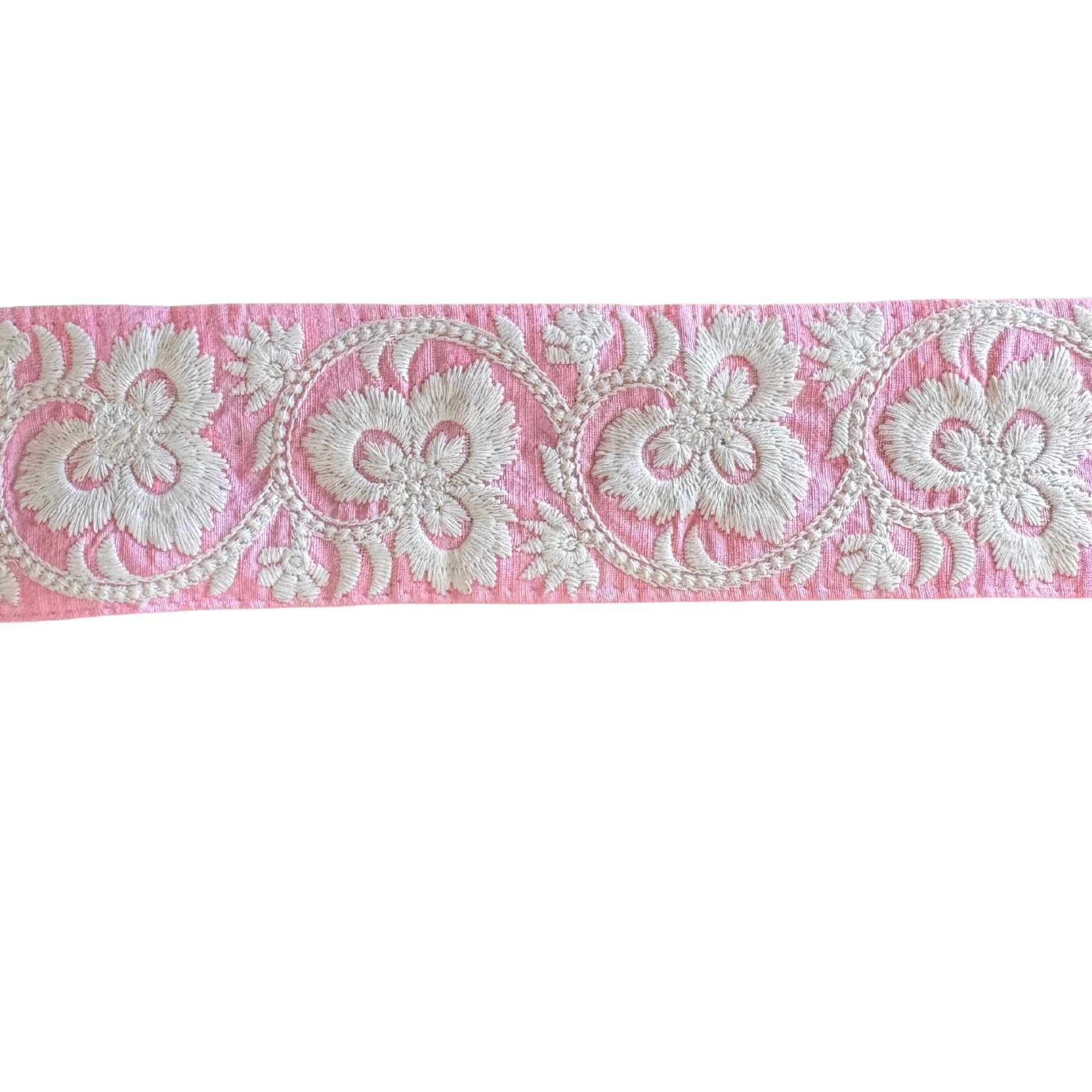 White floral lace on pink fabric