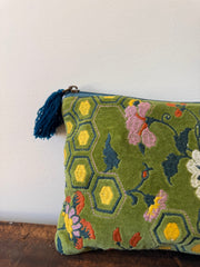 Decorative pillow with floral patterns and a tassel on a white background