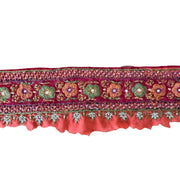 Decorative red fabric with floral embroidery on a white background