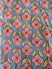 Patterned fabric with pink and orange flowers on a blue background
