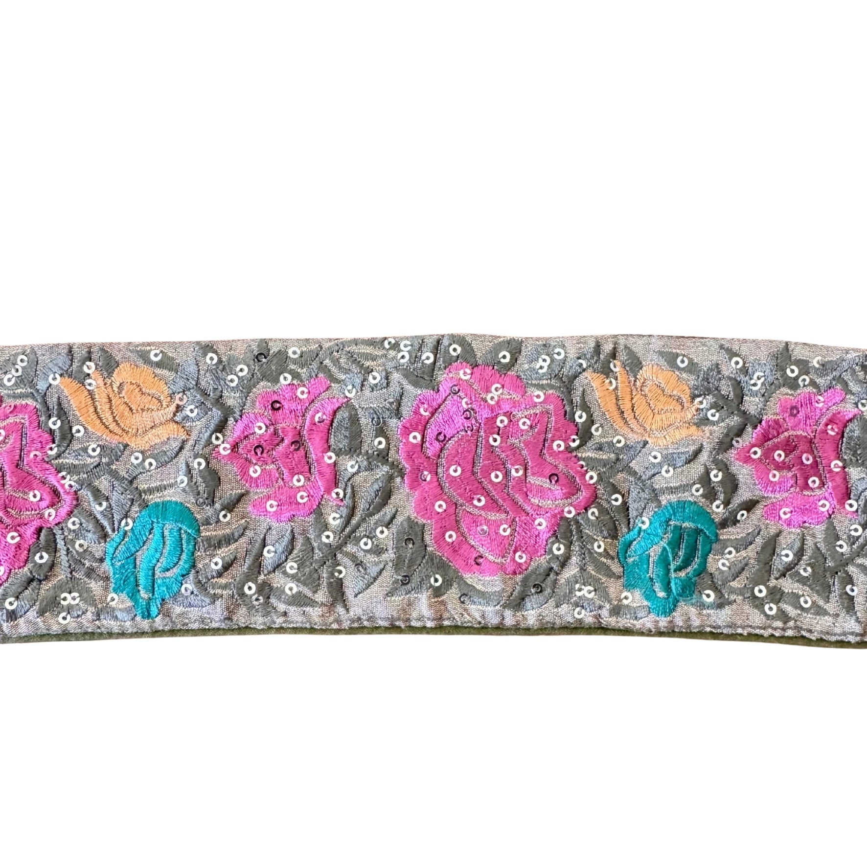 Decorative ribbon with floral patterns and sequins on a white background