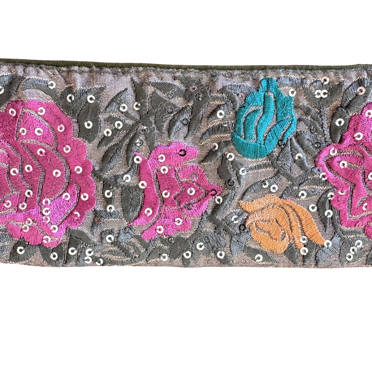 Decorative fabric strip with floral patterns and sequins on a white background