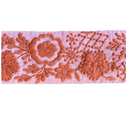 Decorative lace trim with floral patterns on a pink background