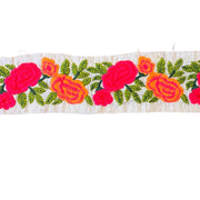 Embroidered floral pattern with pink and orange flowers on a white background