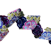 Colorful floral-patterned fabric roll on a white background 