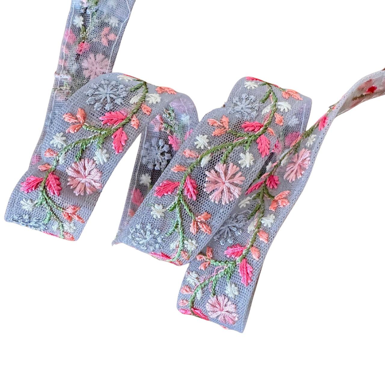 Embroidered floral ribbon with pink and green flowers on a gray background