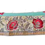 Floral patterned fabric strip with red flowers on a white background