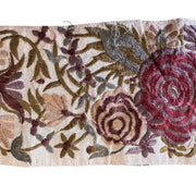 Embroidered fabric with floral patterns on a beige background
