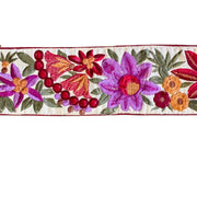 Embroidered floral design with colorful flowers and leaves on a white background