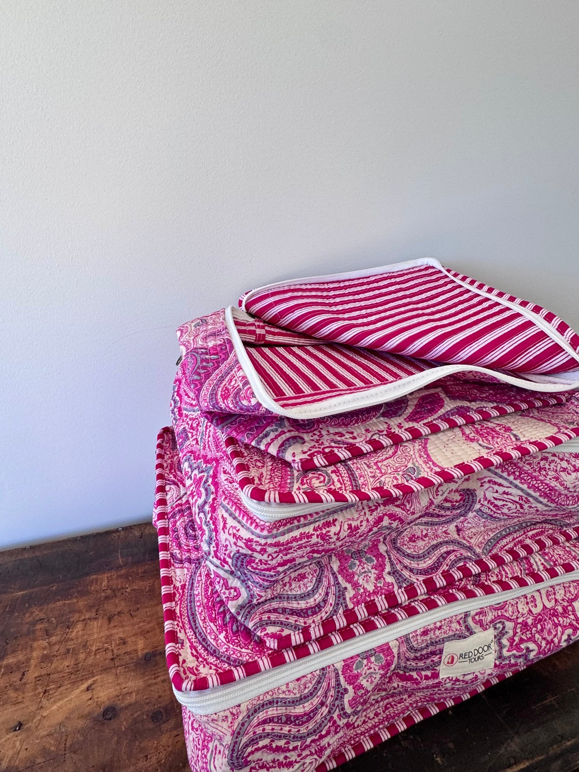 Pink patterned fabric on a wooden surface with a white background
