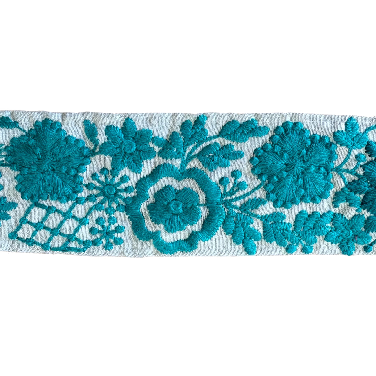 Teal floral embroidery on a white background