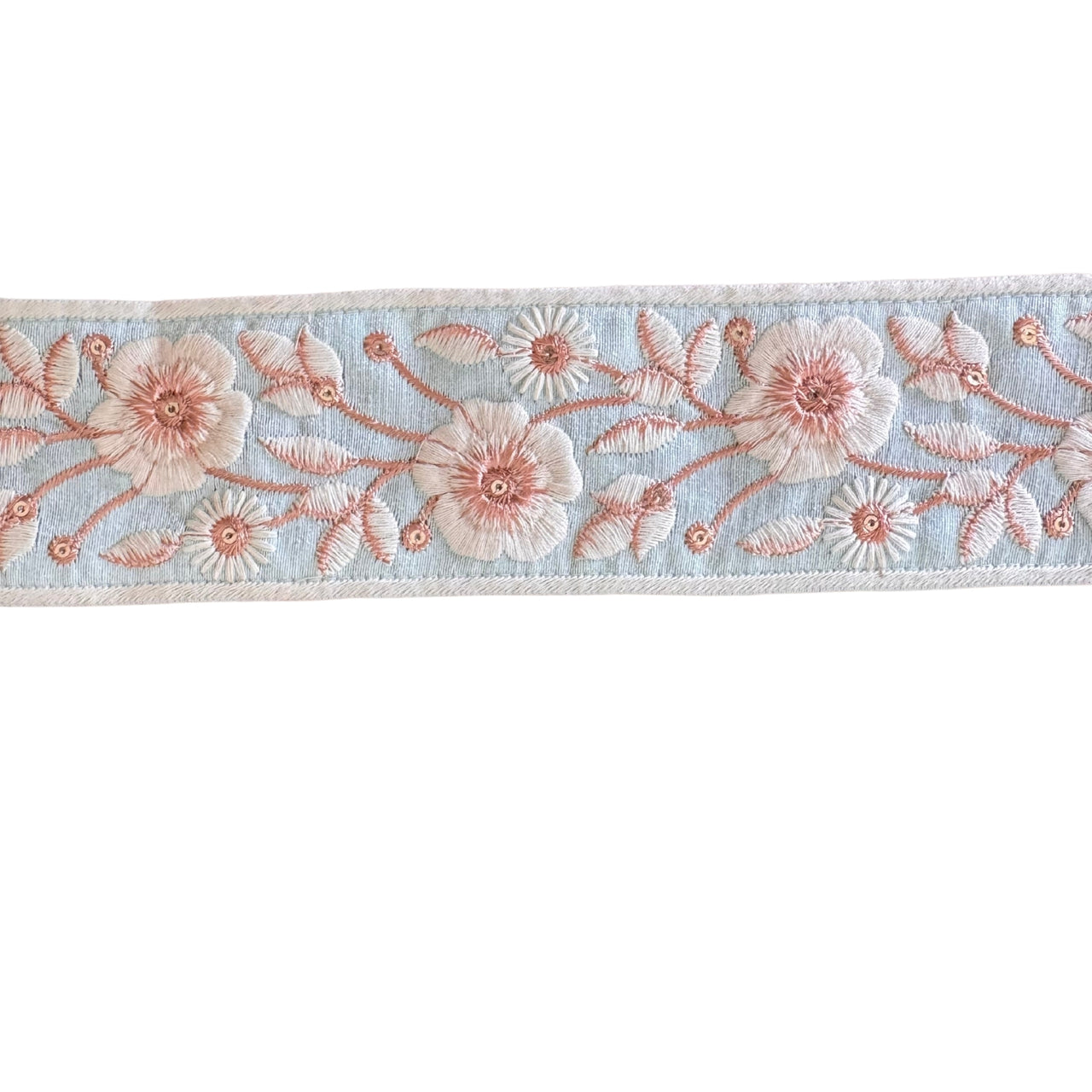 Floral embroidery ribbon with pink flowers on a light blue background