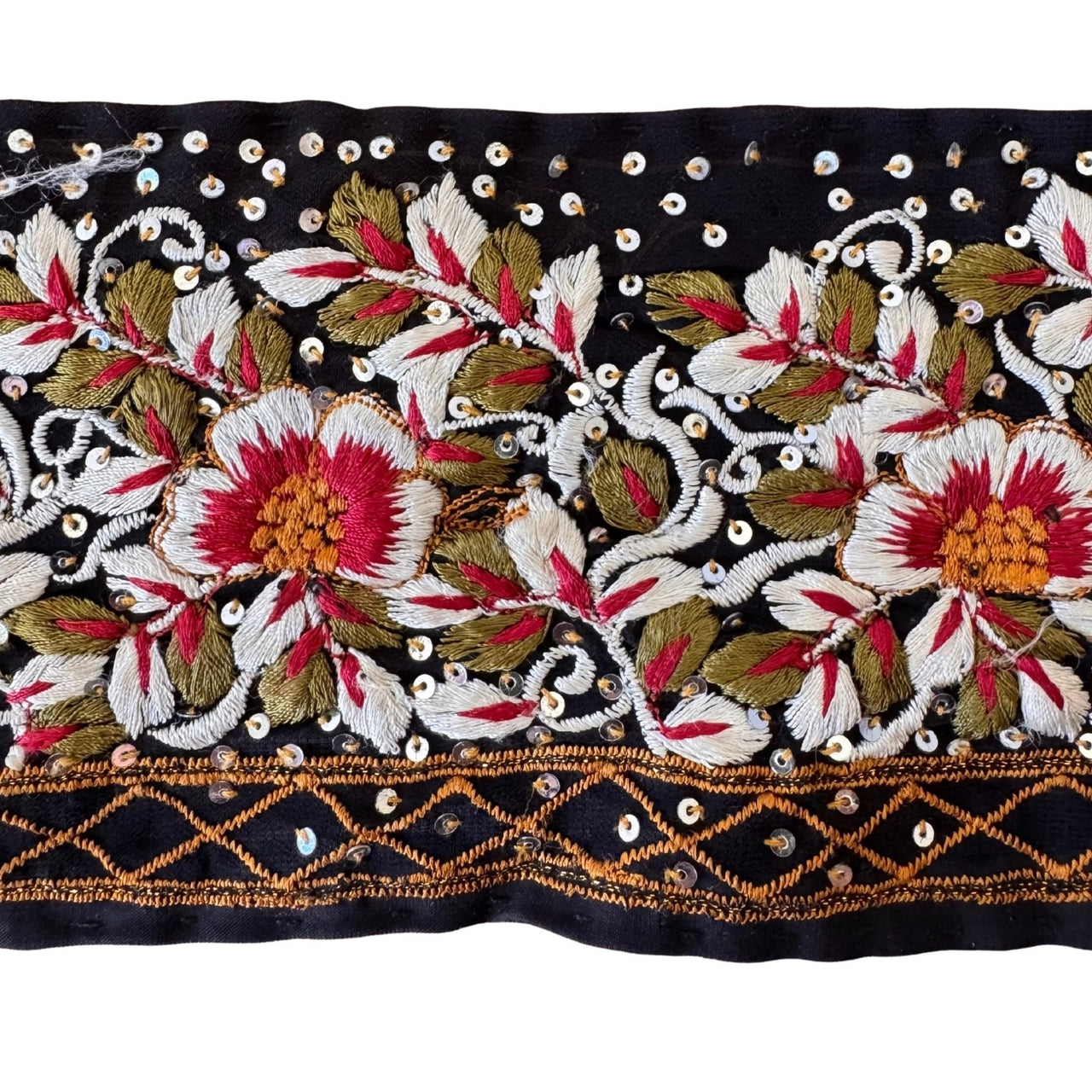 Decorative fabric strip with floral embroidery and beadwork on a black background