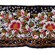 Decorative fabric strip with floral embroidery and beadwork on a black background